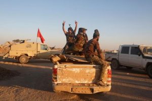 Members of the Shi'ite Badr Organisation fighters ride in a military vehicle during a battle with Islamic State militants at the airport of Tal Afar west of Mosul, Iraq, November 20, 2016. REUTERS/Khalid al Mousily