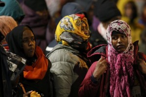 Migrants wait before entering buses as part of their transfer by French authorities to reception centres across the country during the dismantlement of makeshift camps in a street near Stalingrad metro station in Paris, France, November 4, 2016. REUTERS/Benoit Tessier
