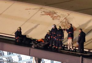epa05669921 Firefighters carry a bodybag on top of the stadium's roof after an explosion around Vodafone Arena Stadium in Istanbul, Turkey, 10 December 2016. At least 13 people were killed in what the Interior Ministry called a car bomb attack after two explosions were heard outside Besiktas Stadium a few hours after the night's soccer match. EPA/TOLGA BOZOGLU