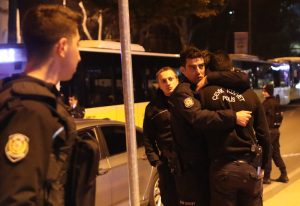 epa05669795 Police officers hug each other after an explosion around Vodafone Arena Stadium in Istanbul, Turkey, 10 December 2016. At least 20 people were wounded in what the Interior Ministry called a car bomb attack after two explosions were heard outside Besiktas Stadium. EPA/SEDAT SUNA