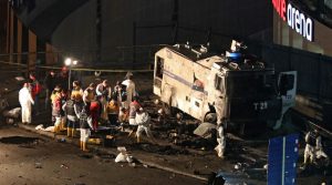 epa05670018 Crime scene investigators work next to a damaged water cannon as others carry a bodybag at the scene of an explosion around Vodafone Arena Stadium in Istanbul, Turkey, late 10 December 2016. At least 13 people were killed in what the Interior Ministry called a car bomb attack after two explosions were heard outside Besiktas Stadium a few hours after the night's soccer match. EPA/TOLGA BOZOGLU