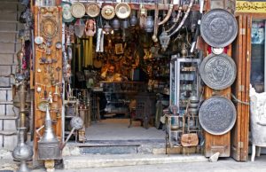 A vendor sits inside an antique shop in al-Jdeideh neighbourhood, in the Old City of Aleppo, Syria December 12, 2009. REUTERS/Khalil Ashawi