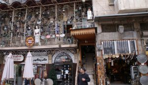 A man stands outside an antiques shop in al-Jdeideh neighborhood, in the Old City of Aleppo, Syria December 12, 2009. REUTERS/Khalil Asia