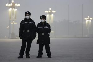 Policemen wear protective masks at the Tiananmen Square on an extremely polluted day as hazardous, choking smog continues to blanket Beijing, China December 1, 2015. REUTERS/Damir Sagolj/File Photo