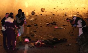 epa05670001 Crime scene investigators inspect a police officer's body at the scene after an explosion around Vodafone Arena Stadium in Istanbul, Turkey, 10 December 2016. According to security source at least 13 people were killed in what the Interior Ministry called a car bomb attack after two explosions were heard outside Besiktas Stadium a few hours after the night's soccer match. EPA/SEDAT SUNA ATTENTION EDITORS: PICTURE CONTAINS GRAPHIC CONTENT