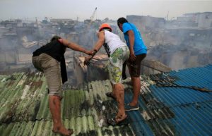 Residents looks at the damage after a fire destroyed more than hundreds of shanties at a community of informal settlers, according to authorities, in Parola Compound, Tondo city, metro Manila, Philippines February 8, 2017. REUTERS/Romeo Ranoco