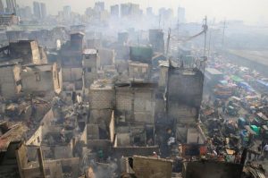 Residents gather after a fire destroyed more than hundreds of shanties at a community of informal settlers, according to authorities, in Parola Compound, Tondo city, metro Manila, Philippines February 8, 2017. REUTERS/Romeo Ranoco
