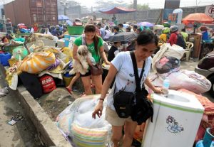 Fire victims gathers along a street after a fire destroyed more than hundreds of shanties at a community of informal settlers, according to authorities, in Parola Compound, Tondo city, metro Manila, Philippines February 8, 2017. REUTERS/Romeo Ranoco